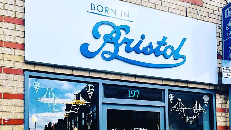 Storefront with 'Born in Bristol' sign and window displays.